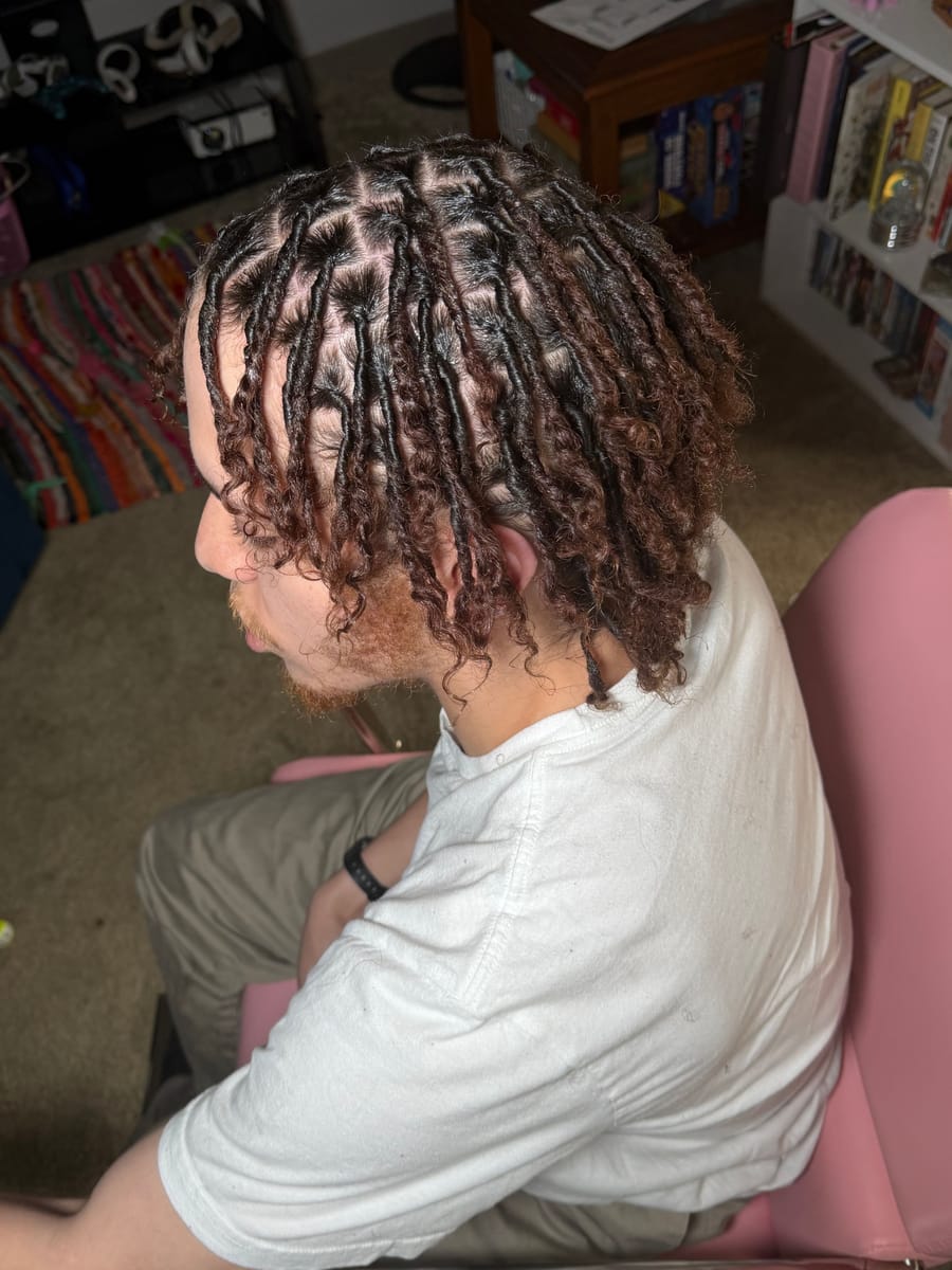 Fresh retwist with defined curly ends, side view